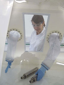 Biochemist Dr Nefeli Tsaloglou sterilises water sample bottles in the isolation tent