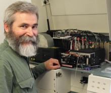 Professor Mikhail Zubkov beside the human blood counting machine