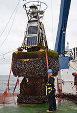 Adrian Bunting, MetO, with the barnacle-encrusted PAP 1 ODAS buoy