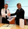 Commodore Guy Robinson from Navy Command Headquarters shaking hands with Geraint West, the NOC’s Director of National Marine Facilities after the signing of the Memorandum of Understanding